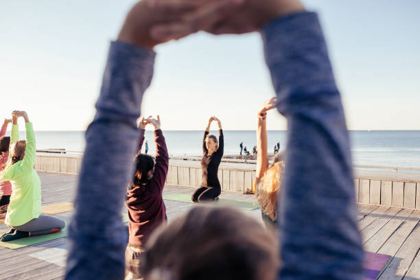istock group of sporty people practicing yoga 1204427094