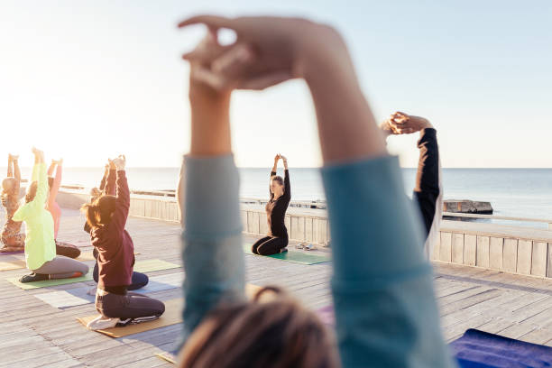istock group of sporty people practicing yoga 1204427163
