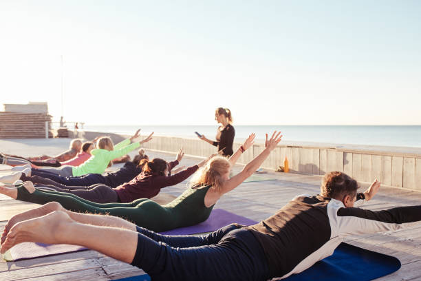 istock group of sporty people practicing yoga 1204427226