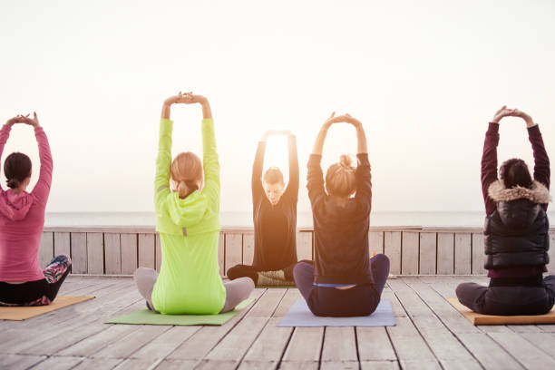 istock group of sporty people practicing yoga 1204427885