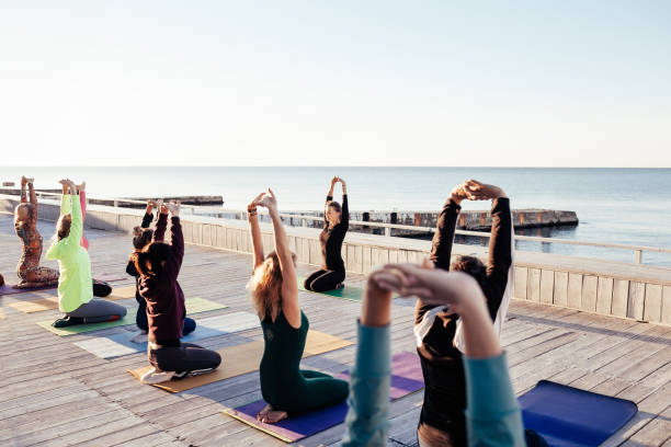 group of sporty people practicing yoga