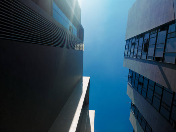 istock Modern skyscrapers in business district at sunset with lens flare effect 1204433476