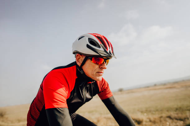Portrait of a senior cyclist Photo of a senior cyclist during the triathlon training cycling helmet photos stock pictures, royalty-free photos & images