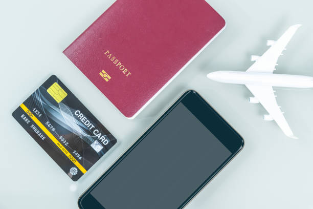 istock Smartphone and passport on white 1204434015