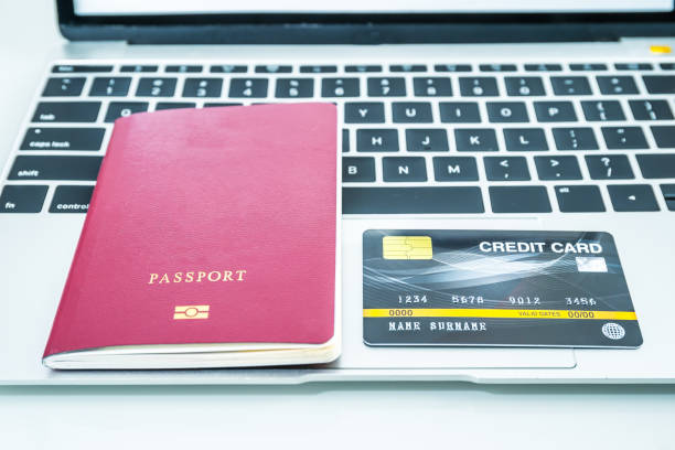 istock Credit card and passport on keyboard 1204434018