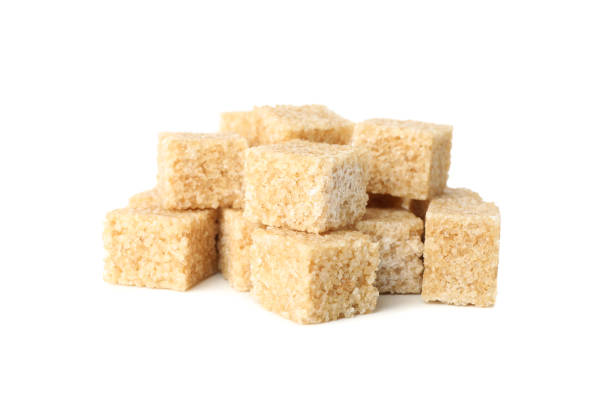 istock Brown sugar cubes isolated on white background, close up 1204434168