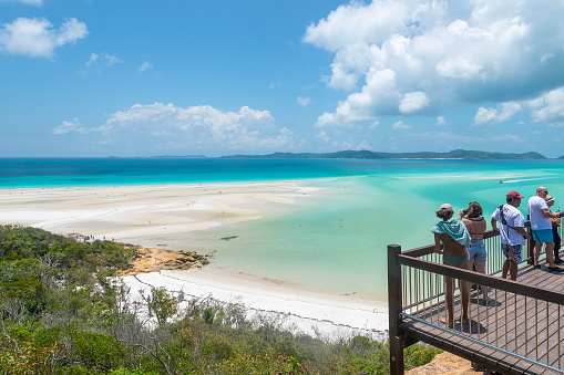 Whitsundays, Queensland, Australia - February 5, 2020: A group of people admiring the view and taking pictures at the Whitsunday Island Lookout.