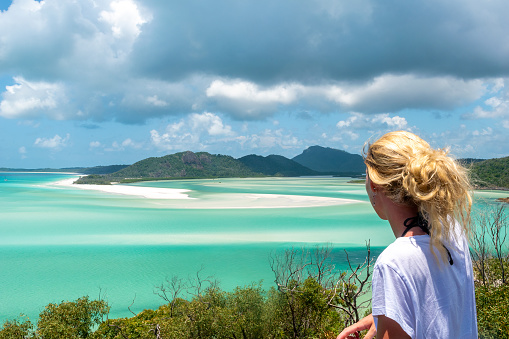 Whitsundays, Queensland, Australia - February 5, 2020: A person admiring the view of the beach at Whitsunday Island.