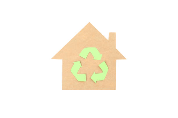 istock Cardboard house with recycle sign isolated on white background 1204435353