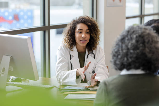 istock Female doctor gestures while talking with female patient 1204436167