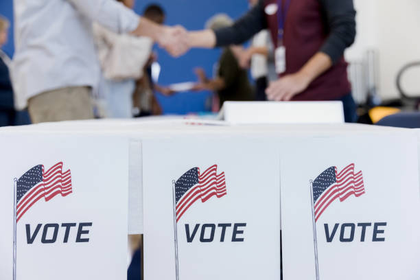istock Focus on voting posters on end of table 1204436335