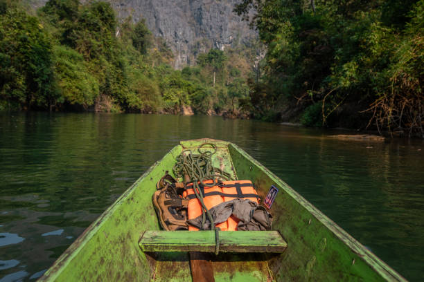 Wooden boat with life vests at Konglor Cave, Thakhek, Laos stock photo