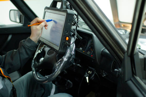 istock Autodiagnostics. Professional car mechanic working in a service station. 1204436561