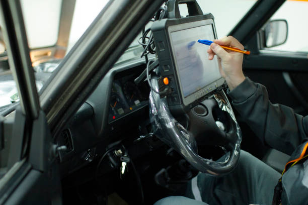 istock Autodiagnostics. Professional car mechanic working in a service station. 1204436622