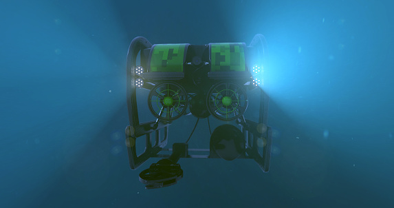 A deep sea ROV - remote operated vehicle, with it's lights penetrating the darkness of the bottom of the ocean