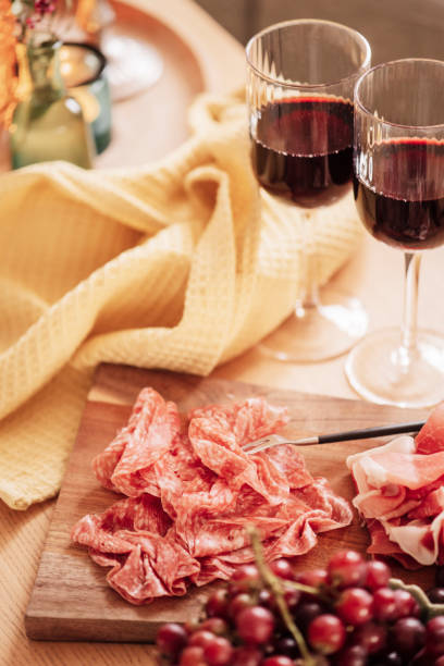 istock Red wine and cold cuts meat indoors on table 1204437000