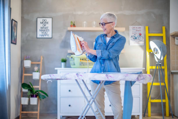 istock Beautiful senior woman ironing her clothes. 1204437054