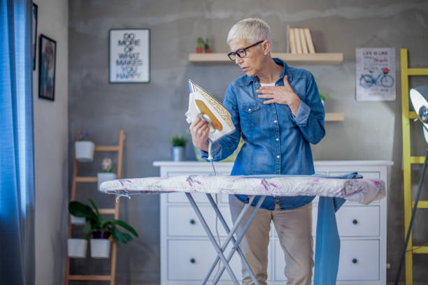 istock Beautiful senior woman ironing her clothes. 1204437919