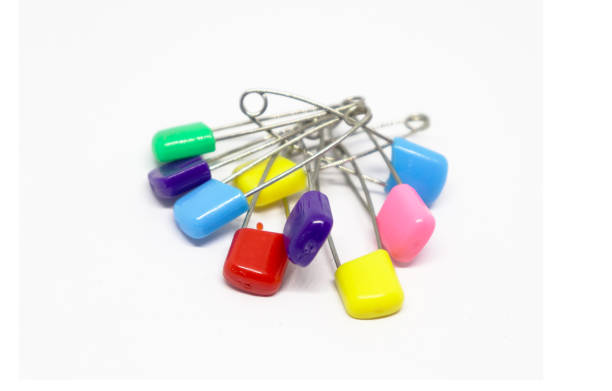 istock Colorful safety pin isolated on white background 1204438979