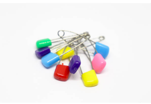 istock Colorful safety pin isolated on white background 1204438995