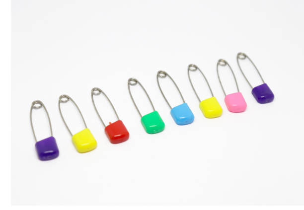 istock Colorful safety pin isolated on white background 1204439000