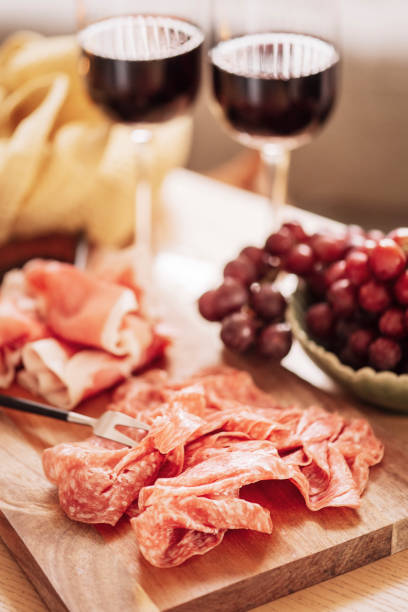 istock Red wine and cold cuts meat indoors on table 1204439163
