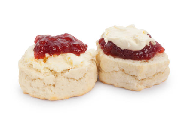 Cornish and Devon Scones, Clotted Cream and Jam Studio shot of homemade scones, clotted cream and strawberry jam. It is traditional in the county of Cornwall, UK to have the cream on top of the jam. In Devon, UK, the jam is on top. devon photos stock pictures, royalty-free photos & images