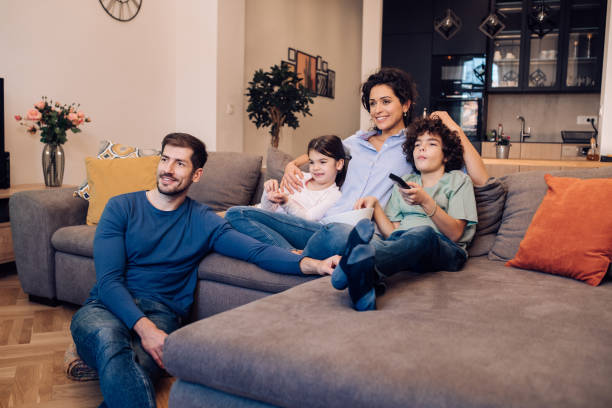 istock Family watching TV show 1204439626