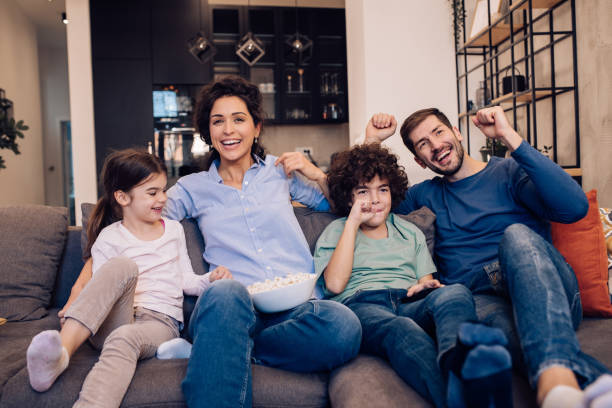 istock Family spending a nice evening on the couch, watching TV 1204439635
