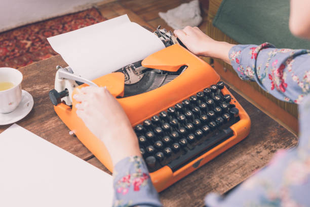 istock Woman writing on an old typewriter. 1204442743