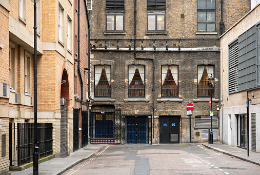 Various buildings in a quiet backstreet in London's Soho district.
