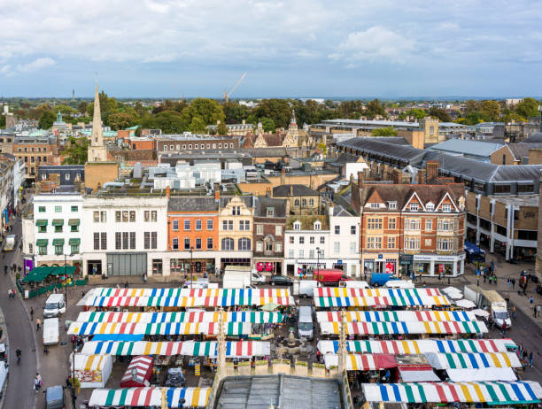 Market Square in Cambridge, England A high angle view over Market Square in Cambridge, with a large number of stalls under shelters, surrounded by shopping streets. cambridge england stock pictures, royalty-free photos & images