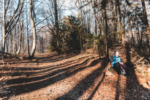 A tourist resting on the trail during a mountain hike. Southeast Poland.