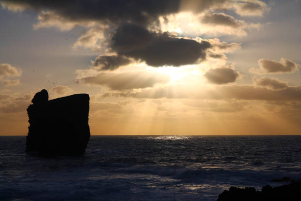 istock The sunset on the ocean with the stones 1204444180