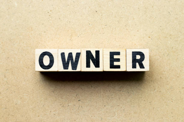 istock Letter block in word owner on wood background 1204444418