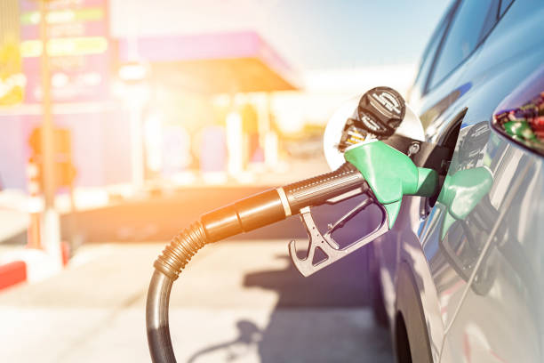 istock Handle fuel nozzle refueling vehicle at gas station 1204447252
