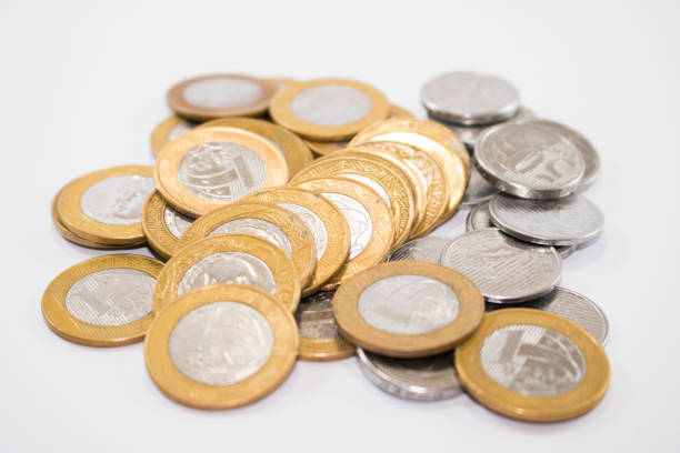istock A portion of yellow and silver coins on a white background 1204447417