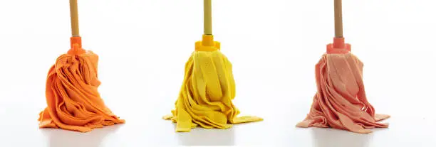 Photo of Cleaning floor mops set isolated against white background.