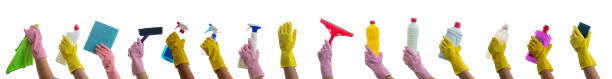 istock Cleaning supplies on gloved hands isolated against white background. 1204447801