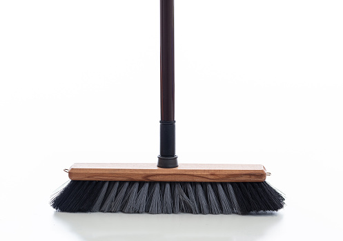 Cleaning push broom isolated against white background. Floor wooden brush with black color stick, household cleaning supplies