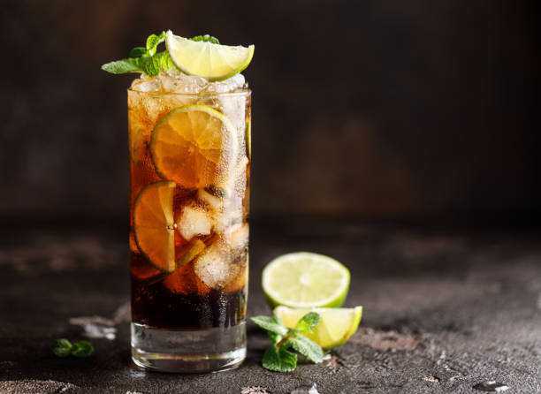 Cuba Libre with brown rum, cola, mint and lime. Cuba Libre or long island iced tea cocktail with strong drinks Cuba Libre with brown rum, cola, mint and lime. Cuba Libre or long island iced tea cocktail with strong drinks cuba libre stock pictures, royalty-free photos & images
