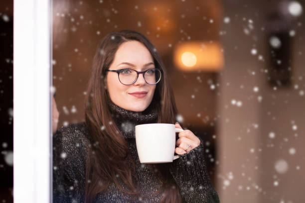 istock Woman relaxing by the window and drinking tea 1204453648