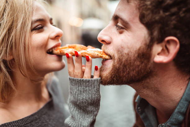 istock friends eating a pizza in italy 1204453993