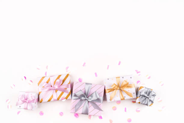 istock Set of gift boxes with bows and confetti on a white background. 1204455229
