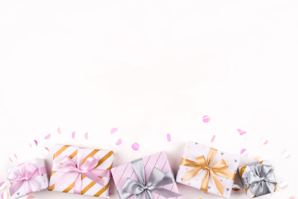 istock Set of gift boxes with bows and confetti on a white background. 1204455256