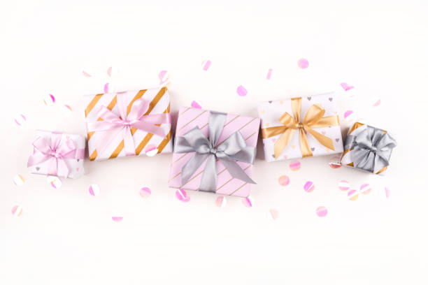 istock Set of gift boxes with bows and confetti on a white background. 1204455341