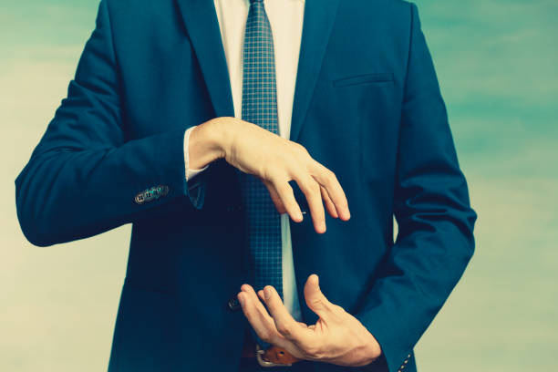 Hands of a man in a blue jacket folded in the shape of a sphere or as if pulling something on blue background Hands of a man in a blue jacket folded in the shape of a sphere or as if pulling something. male is standing and shows outstretched hand with open palm stock pictures, royalty-free photos & images