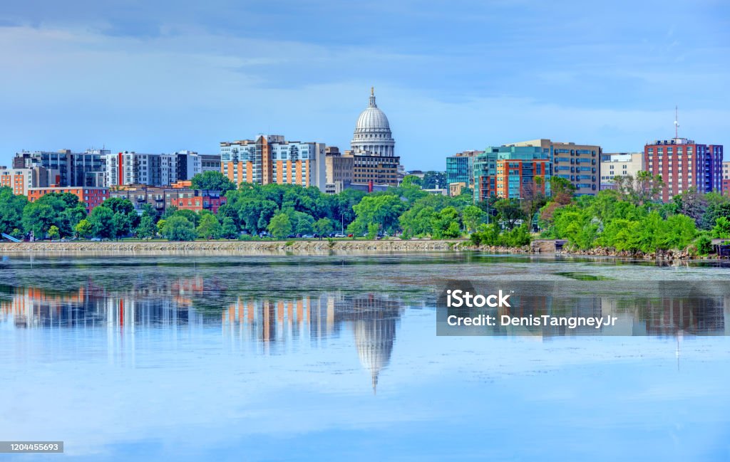 Madison skyline reflecting on Lake Monona Madison is the capital of the U.S. state of Wisconsin and the seat of Dane County. Madison - Wisconsin Stock Photo