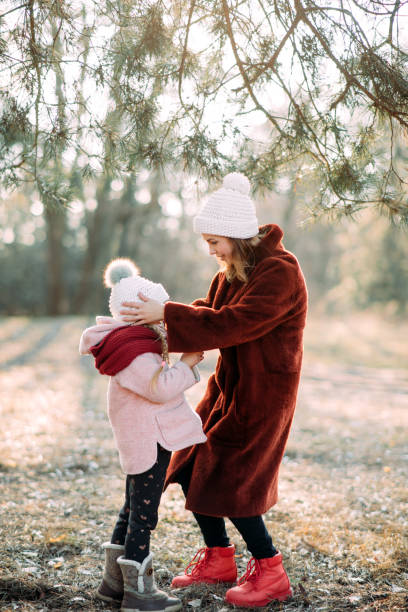 istock Mother and daughter have fun in the pine forest. 1204455860