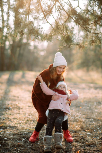 istock Mother and daughter have fun in the pine forest. 1204455952